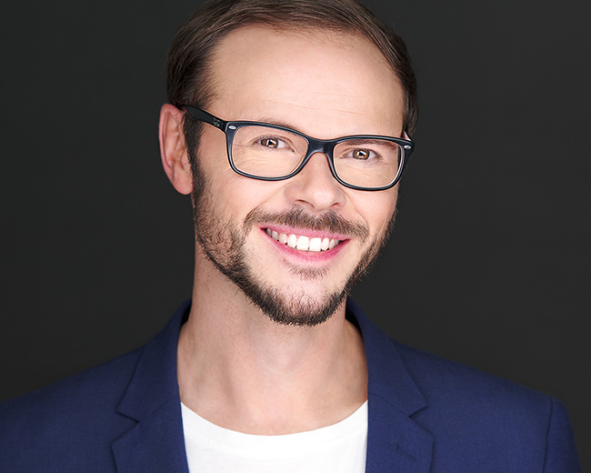Personal Branding Headshot Foto bzw. Business Portrait von Stefan auf dunklem Hintergrund